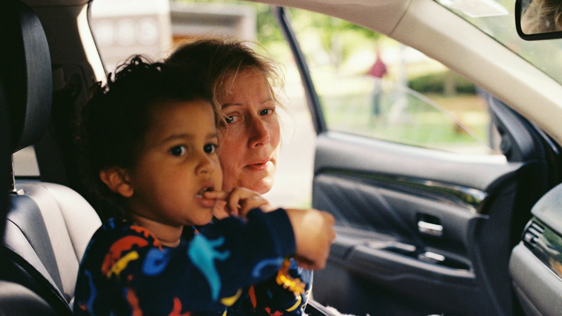 Car window tinting Butler: an adult and a young child sitting together in a car