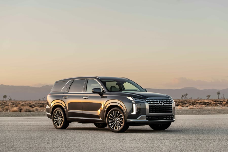 Tinting a family SUV: a large SUV parked on the road at dusk