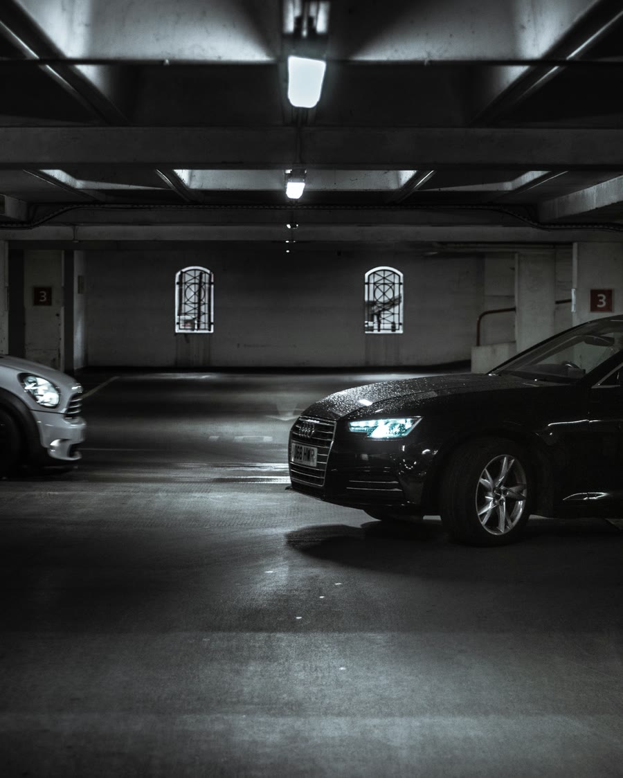 Choosing the right window tint: black sedan with dark windows in a parking garage