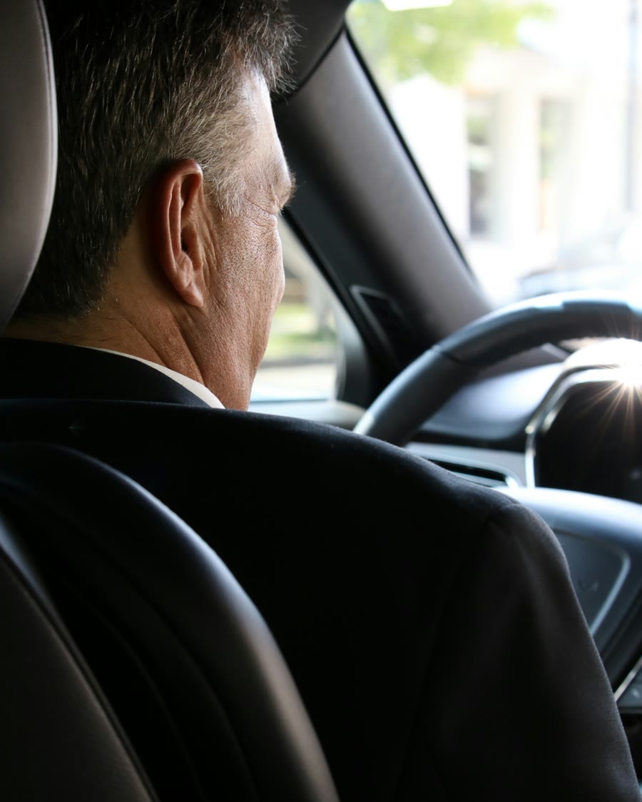 Privacy when driving: a driver seen from the back seat of a car