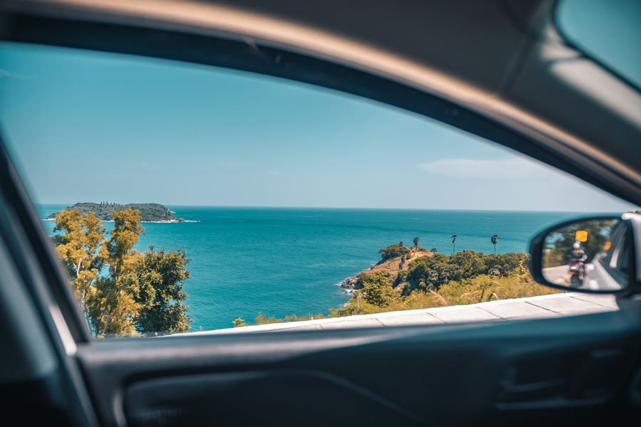 Car window tinting Scarborough: the ocean seen through a car's side window