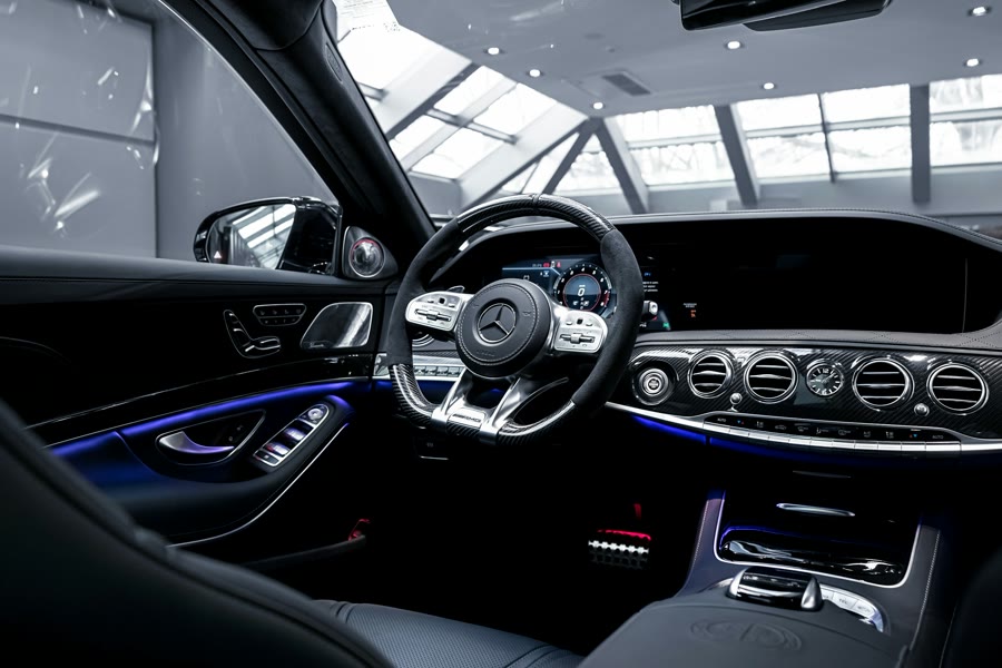 Car window tinting South Perth: a luxury car interior with leather trim and ambient lighting