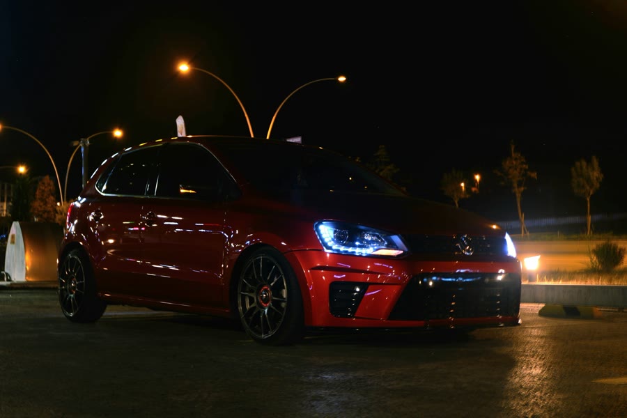 Rideshare window tint: a red car parked in a car park at night