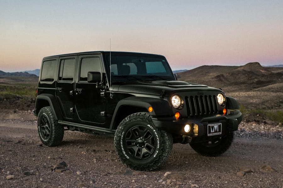 Car window tinting Wanneroo: a black 4WD with dark windows at dusk