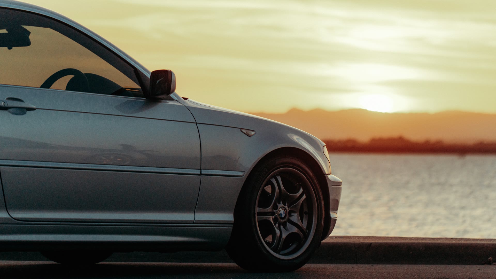 Online quote for mobile car tinting in Perth: sedan with tinted glass at sunset